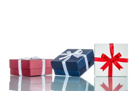 luxury color gift box for holiday event with beautiful silk wrap on white background isolatedの写真素材