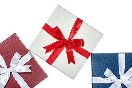 luxury color gift box for holiday event with beautiful silk wrap on white background isolatedの写真素材