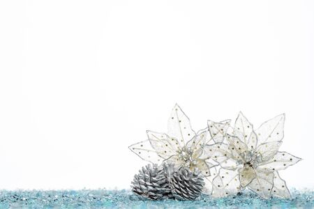 Silver Pine Cone with christmas decoration flower on Snow, isolated on whiteの写真素材