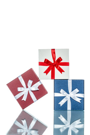 luxury color gift box for holiday event with beautiful silk wrap on white background isolatedの写真素材
