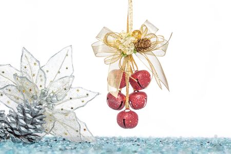 Luxury red jingle Bells, flower and Pine Cone with Snow, hanging Decoration, isolated on whiteの写真素材