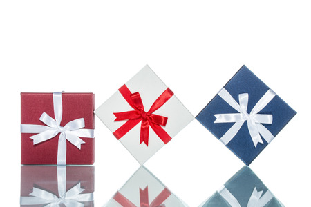 luxury color gift box for holiday event with beautiful silk wrap on white background isolatedの写真素材