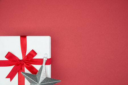 luxury color gift box for holiday event silk wrap snowflake on red background isolatedの写真素材