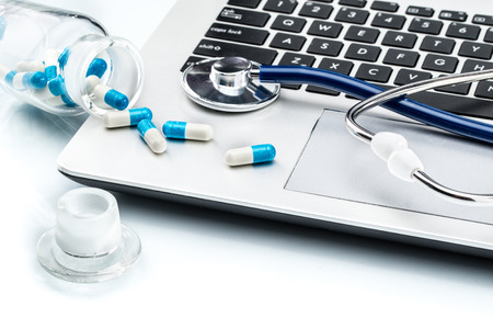 Medical Research, stethoscope and Capsule on laptop keyboard, doctor workplaceの写真素材
