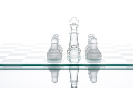 Surrounded king chess, business strategy, transparent glass Chess group War Winning Teamworkの写真素材
