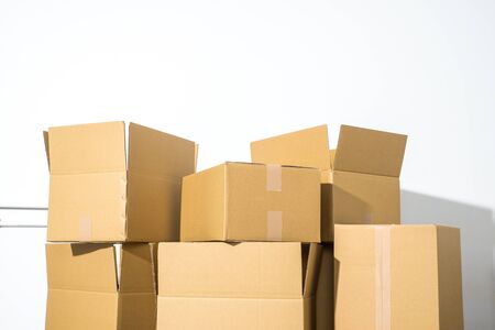 Pile of cardboard boxes on white background with box shadowの写真素材
