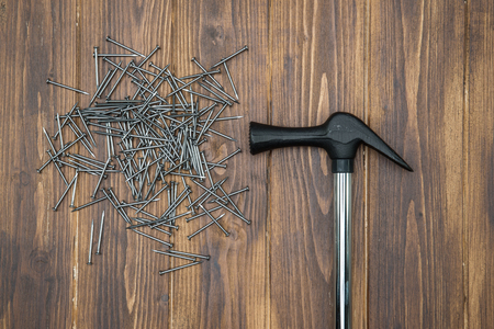 Hammer and nails on brown deck, hand made work toolsの写真素材