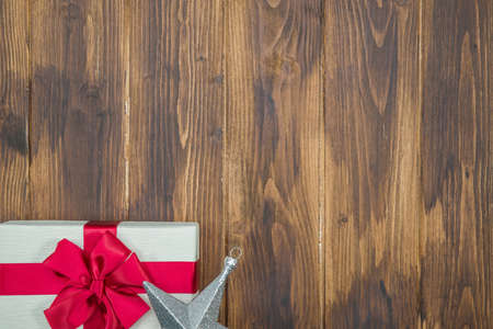 white Gift red silk wrap with star shape on wooden backgroundの写真素材