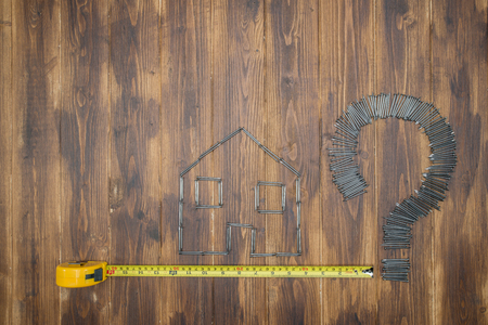 Housing measurement problem, repair by diy, Group of nail on wooden backgroundの写真素材