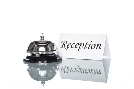 Service bell on the reception desk with white backgroundの写真素材
