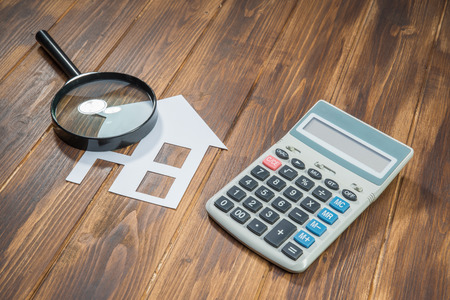 buy house Mortgage calculations concept, calculator with Magnifierの写真素材