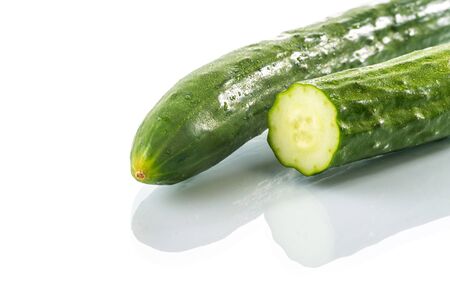 Fresh cucumber cross section on white background, reflectionの写真素材