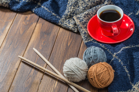 Ball of wool and Coffee on wooden floor, handmade