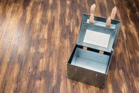 metal box in side of metal box on wooden table, Studio Shotの写真素材
