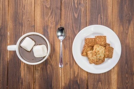 homemade hot chocolate and marshmallow with cookies on wooden tableの写真素材