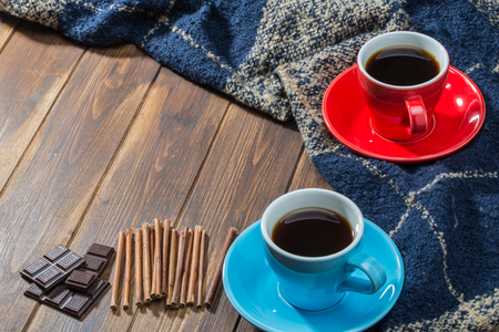 Cinnamon, Blanket and two cups of coffee on wooden floorの写真素材