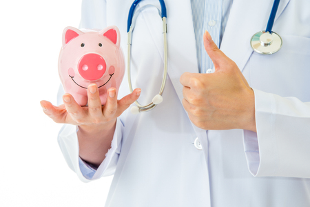 medical insurance, piggybank with stethoscope and thumbs up on white backgroundの写真素材