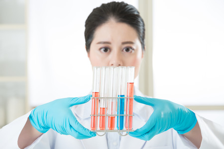 Asian female scientist Asian female scientist Finally a breakthrough Examining test in laboratoryの写真素材