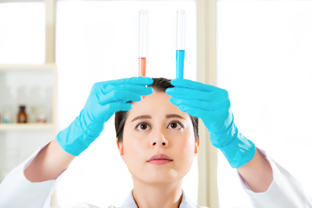 Asian female scientist working on chemical substances in laboratoryの写真素材