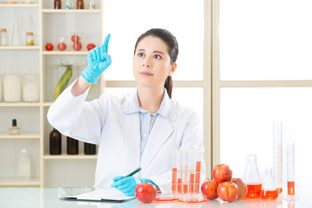 Asian female scientist drop the cure for genetic modification in laboratoryの写真素材