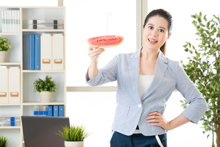asian business woman feel refreshment after try watermelon juice in summerの写真素材