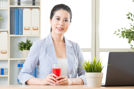 asian business woman feel refreshment after try watermelon juice in summerの写真素材