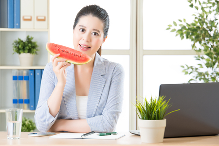 She's always available for business, reduce the summer heat with watermelonの写真素材