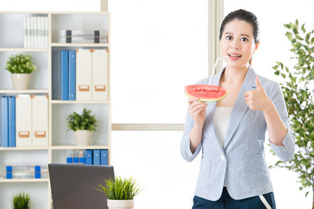 asian business woman feel refreshment after drinking watermelon juice in summerの写真素材