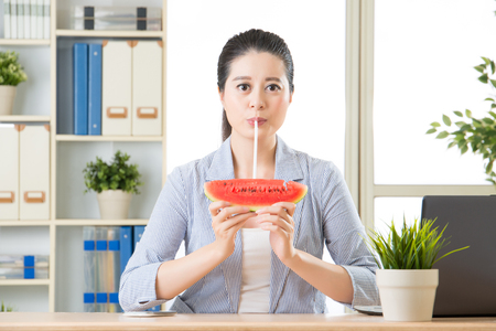 asian business woman drinking summer sweet fruit watermelon juiceの写真素材