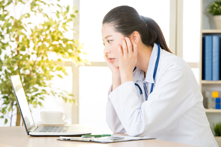 doctor worry about patient's condition using computer, healthcare and medicine concept, hospital office backgroundの写真素材
