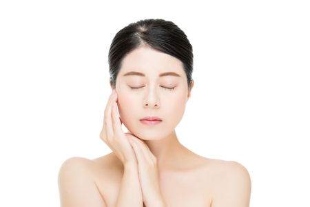 Beautiful face of young adult woman with clean fresh skin isolated on white backgroundの写真素材