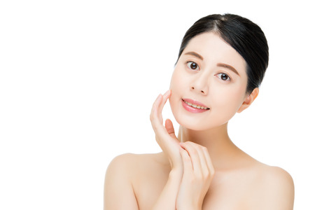 Young asian beauty smile woman touch clean beautiful healthy face, isolated on white backgroundの写真素材