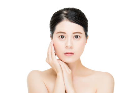 Beautiful face of young adult woman with clean fresh skin isolated on white backgroundの写真素材