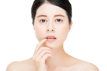 sexy beauty asian woman touch her lips face camera, isolated on white backgroundの写真素材
