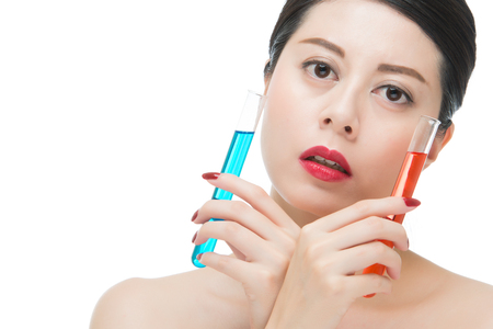look through chemistry liquid tube just like cosmetic on face, isolated on white background, beauty portrait and science conceptの写真素材