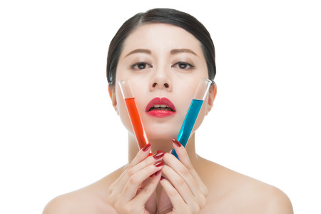 cosmetic just like use toxic chemistry liquid on women face, isolated on white backgroundの写真素材