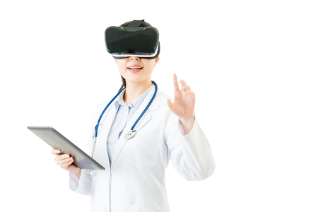 asian female doctor use digital tablet control virtual reality touch screen. VR headset glasses device. white isolated background. medical and health conceptの写真素材