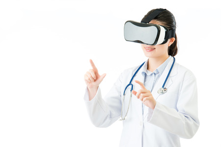 asian female doctor check medical record by virtual reality. VR headset glasses device. white isolated background. medical and health conceptの写真素材
