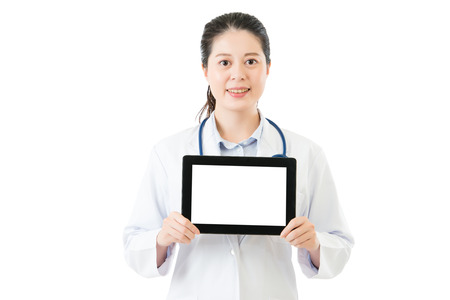 beauty asian doctor showing blank digital tablet pad. isolated on white background. health and medical conceptの写真素材