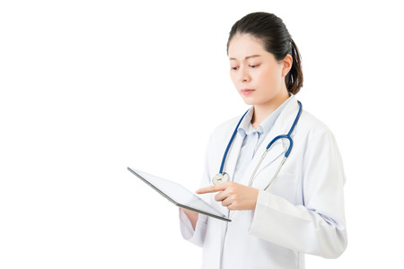 beauty asian doctor using digital tablet pad touch screen. isolated on white background. health and medical conceptの写真素材