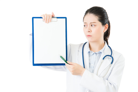 beauty asian doctor pointing showing blank clipboard. isolated on white background. health and medical conceptの写真素材