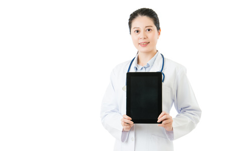 beauty asian doctor showing blank digital tablet pad. isolated on white background. health and medical conceptの写真素材