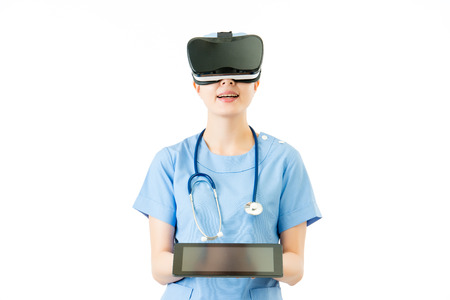 asian female surgeon show digital tablet presenting virtual reality. VR headset glasses device. white isolated background. medical and health conceptの写真素材