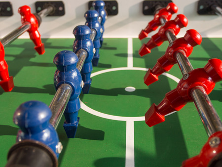 Table football game with red and blue players team in table soccer or football kicker game,の写真素材