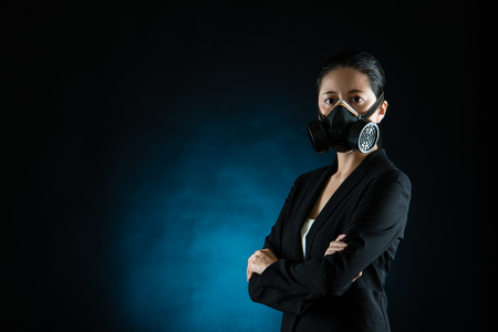 Asian business woman wear face mask in pollution city. concept of industry air pollution. mixed race asian chineseの写真素材