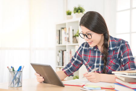 student woman browsing online with notebook digital education concept. mixed race asian chinese model.の写真素材