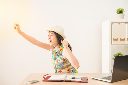 happy business people excited celebrate to achieve results time going to vacation. holiday and travel concept. mixed race asian chinese model.の写真素材