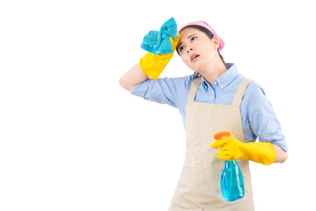 Cleaning woman feel tired and exhausted after finish cleaning the house home. isolated on white background for easy addition of copy space.の写真素材