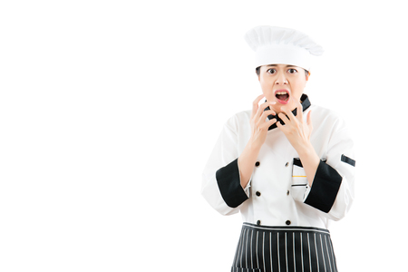 angry asian cook woman feel crazy and shouting cant believe what she see. isolated on white background. profession and industry job concept.の写真素材