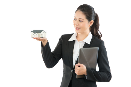 smiling house agent can helping customer choosing the most suitable house residential for family isolated on the white background through online with mobile pad computer over copyspace blank.の写真素材